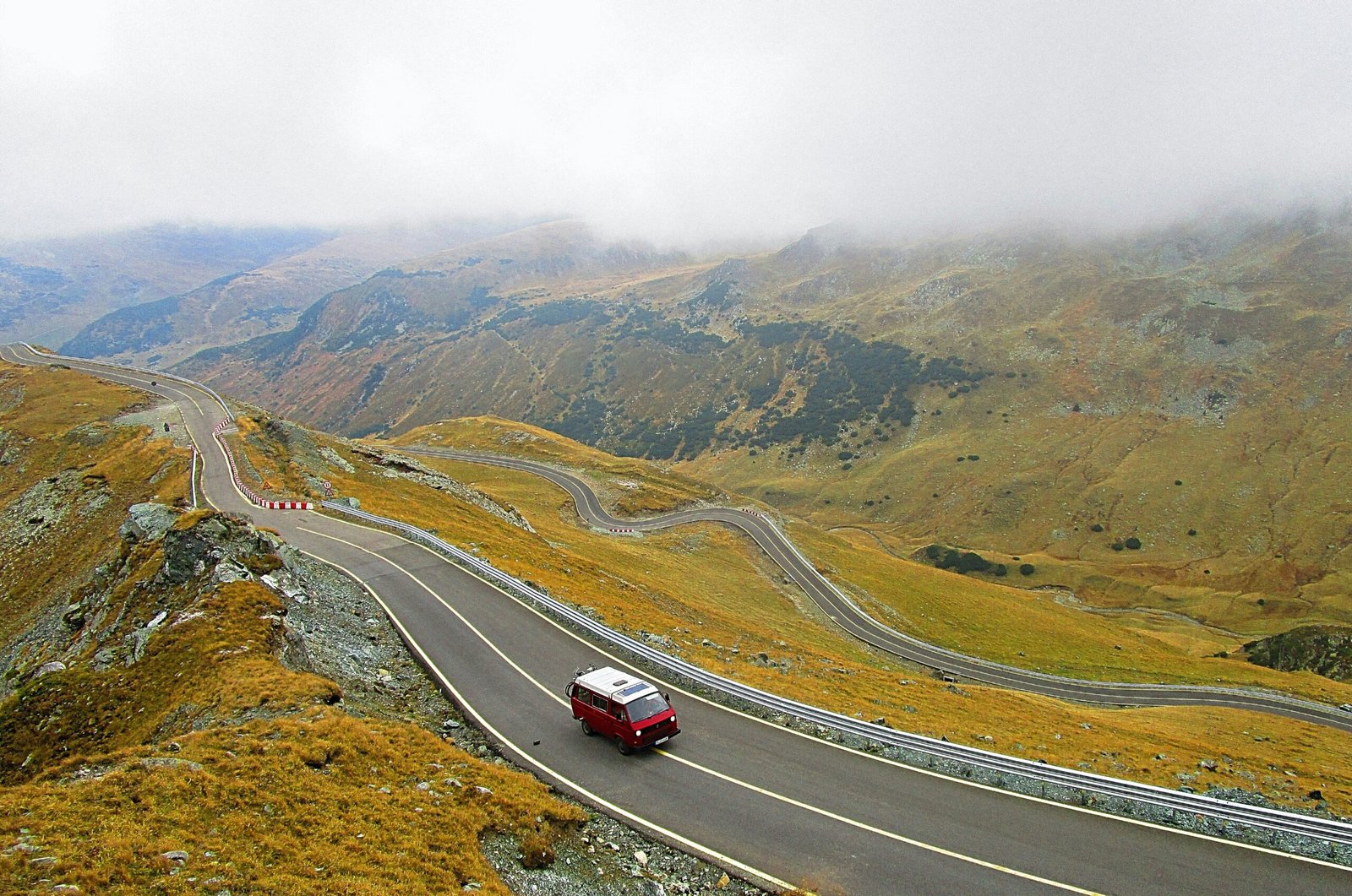 aerial photography of white and red vehicle on road during daytime